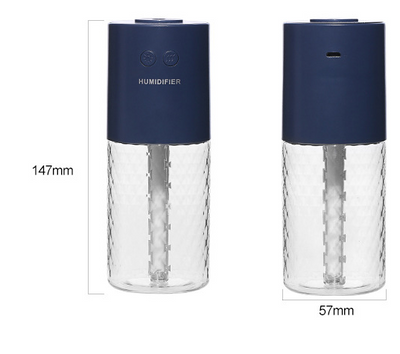 Dark blue and clear portable humidifier with a textured water tank on a white desk next to a laptop. - Image 3