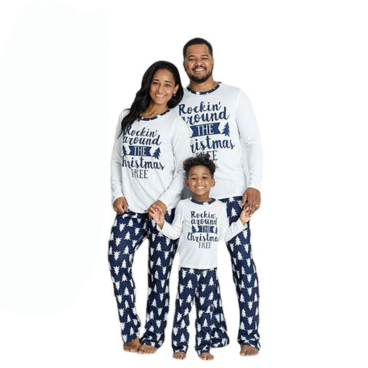 Family of three wearing matching white and navy blue Christmas pajamas with "Rockin' around THE Christmas TREE" text. - Image 10