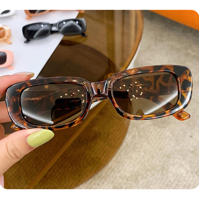 Children's small frame oval sunglasses with a solid white PC frame and brown AC lenses for UV protection. - Image 3