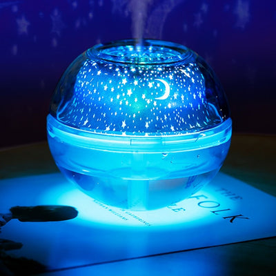 Silver and clear spherical essential oil diffuser with a starry night LED projector, featuring moon and star patterns. - Image 8