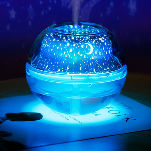 Silver and clear spherical essential oil diffuser with a starry night LED projector, featuring moon and star patterns. - Image 8