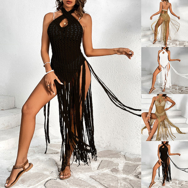 Black crochet beach cover-up with a cross-collar halter neckline and long fringe tassels, worn over a bikini.