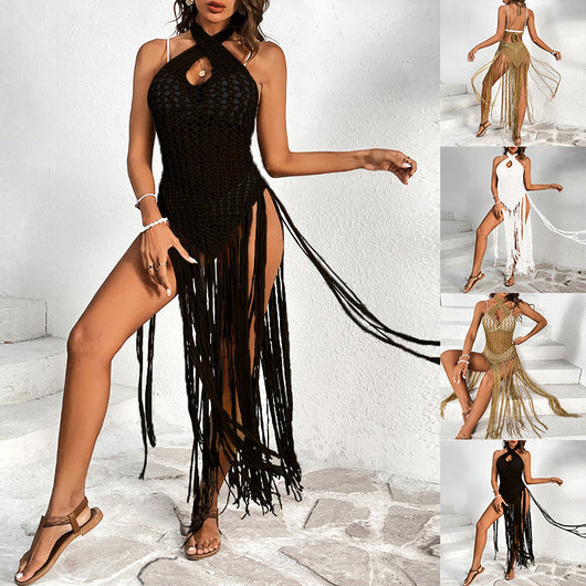 Black crochet beach cover-up with a cross-collar halter neckline and long fringe tassels, worn over a bikini.