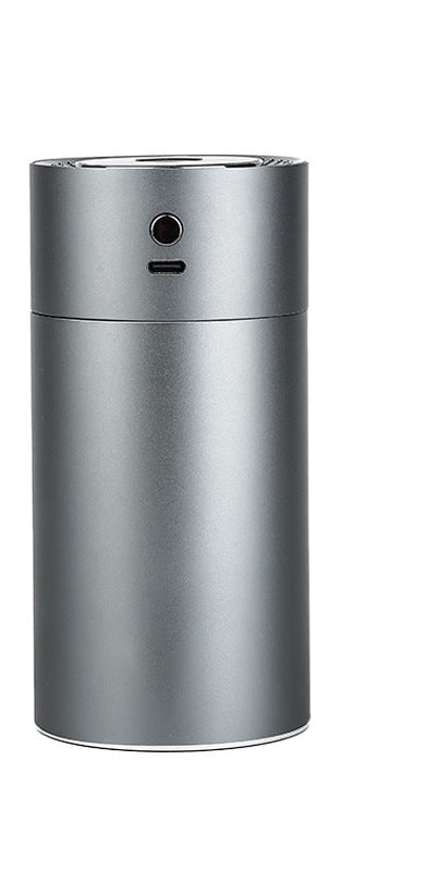 Black cylindrical vehicular humidifier with a silver trim and a vertical indicator light on a white background. - Image 2