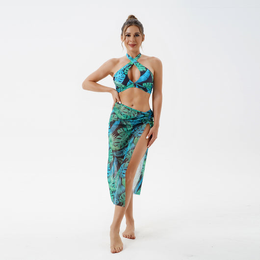Women's plus size split swimsuit with a blue and green tropical leaf print halter bikini top and matching sarong skirt. - Image 37