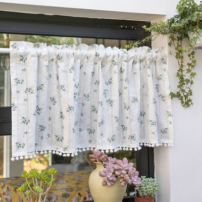White semi-sheer curtain with green and grey floral pattern and cream tassel trim, hanging in a window. - Image 4