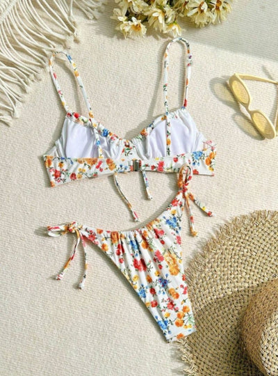 Women's white floral two-piece bikini with red, orange, and blue flowers, featuring a tie-front top and tie-side bottoms. - Image 15