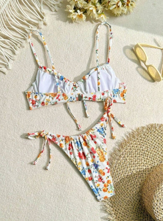 Women's white floral two-piece bikini with red, orange, and blue flowers, featuring a tie-front top and tie-side bottoms. - Image 15