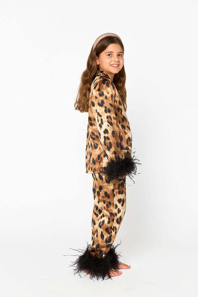 Young girl in a leopard print pajama set with black feather trim on the cuffs and ankles, wearing a pink glitter headband. - Image 24