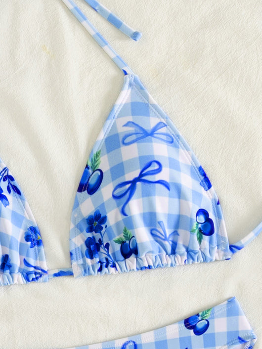 Resort-style blue and white gingham bikini set with blueberry and bow print, featuring a halter triangle top and high-cut bottoms. - Image 14