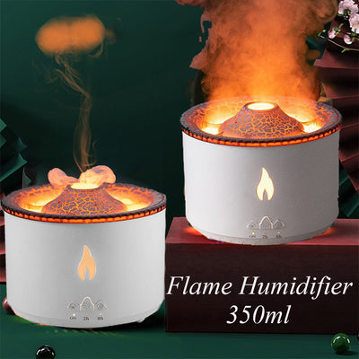 White ultrasonic essential oil diffuser with orange flame effect mist, alongside a gift set of Lavender, Peppermint, Tea Tree, and Sweet Orange essential oils. - Image 4