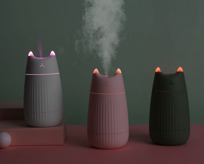 Pink cat-shaped humidifier with pointed ears and a ribbed texture on the lower body, ideal for desktop use. - Image 6