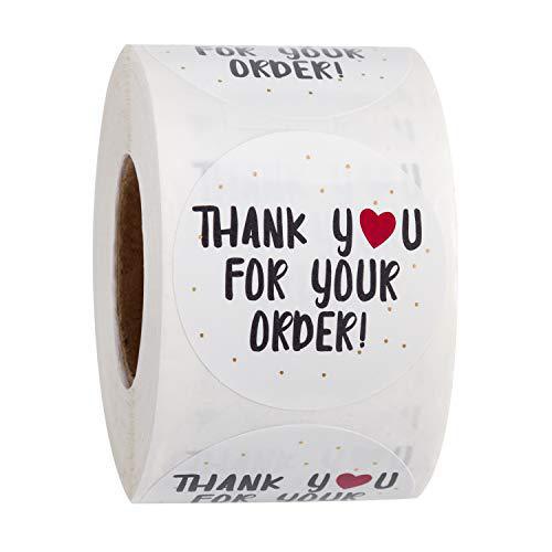 Roll of white round thank you stickers with black text, a red heart, and gold dots for orders.
