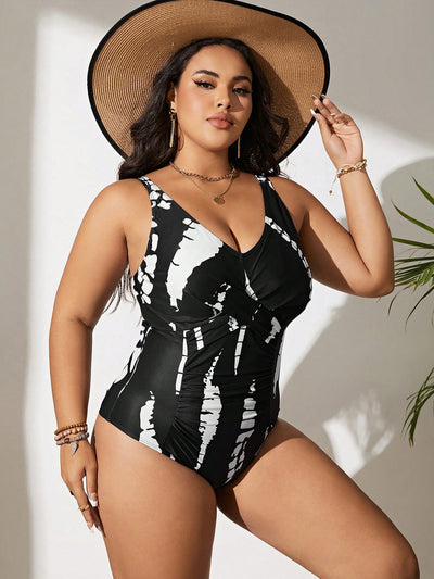 Plus size black and white tie-dye one-piece swimsuit with a V-neck and ruched detailing, worn by a model. - Image 10