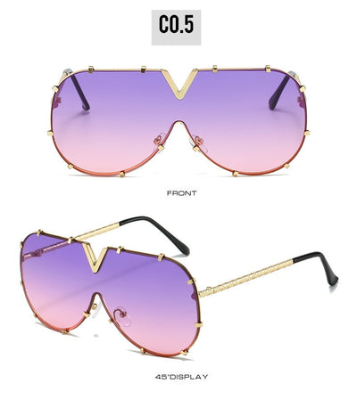 Oversized V-shaped sunglasses with a gold metal frame, white accents, clear lenses, and decorative rivets. - Image 12