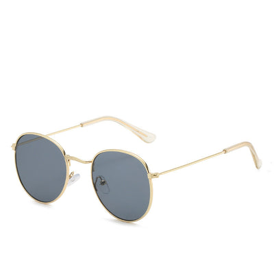 Round gold-framed sunglasses with pink tinted lenses, featuring clear temple tips. - Image 11