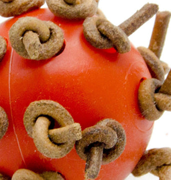 Red plastic interactive chewing ball with brown leather rope knots, next to a green parrot. - Image 5
