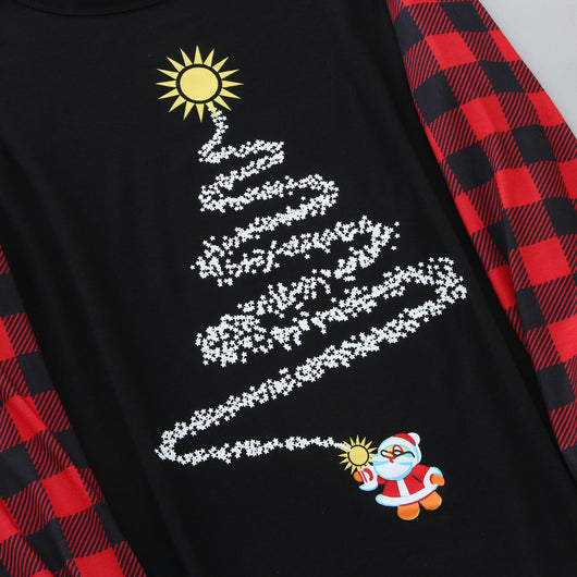 Family of five wearing matching black and red buffalo plaid Christmas pajamas with a white Christmas tree print. - Image 3