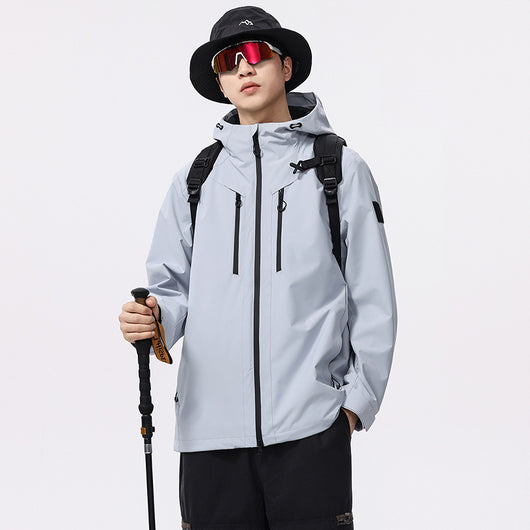 Man wearing a black windproof and waterproof outdoor jacket with a hood, sports sunglasses, and a bucket hat, holding a trekking pole. - Image 3