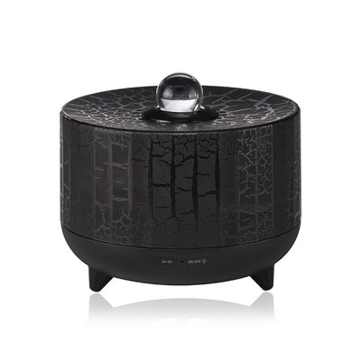 Black cylindrical aromatherapy diffuser with a crackle pattern, clear spherical top, and control buttons for timer and light. - Image 3