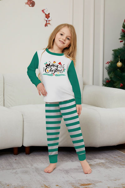Family of four wearing matching green and white striped Christmas pajamas with "Merry Christmas" graphic. - Image 13
