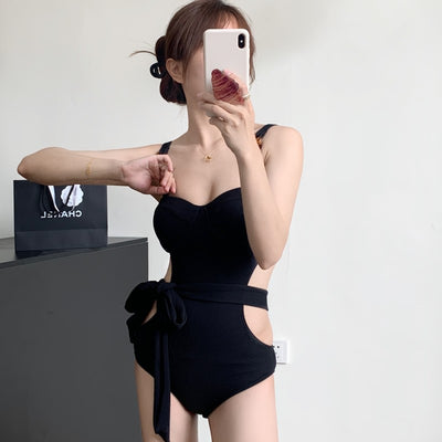 Black ribbed one-piece swimsuit with sweetheart neckline, chain-link shoulder strap, side cut-outs, and self-tie waist. - Image 4