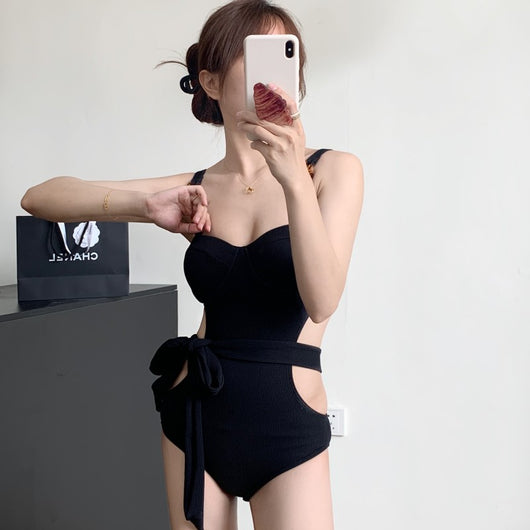 Black ribbed one-piece swimsuit with sweetheart neckline, chain-link shoulder strap, side cut-outs, and self-tie waist. - Image 4