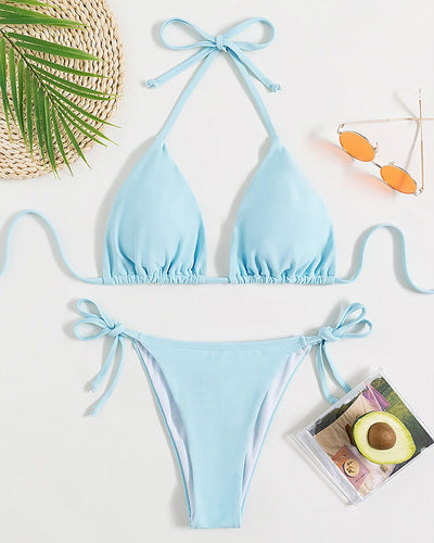 Neon yellow halter bikini with triangle top and tie-side bottoms, displayed on a light wood surface. - Image 14
