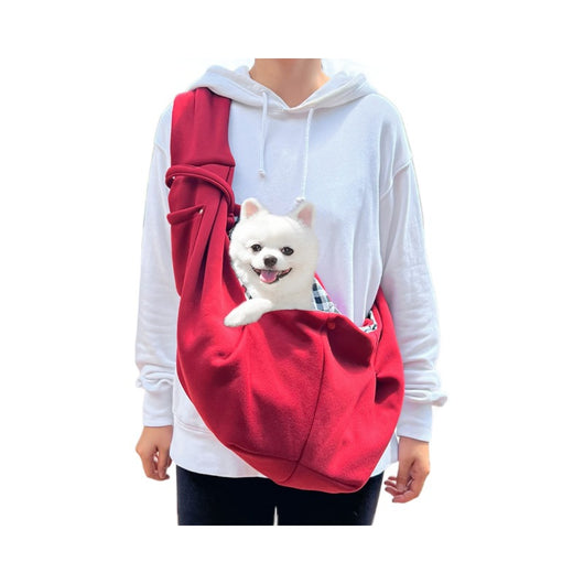 Person in white hoodie carrying a happy white dog in a navy blue pet sling bag outdoors. - Image 5