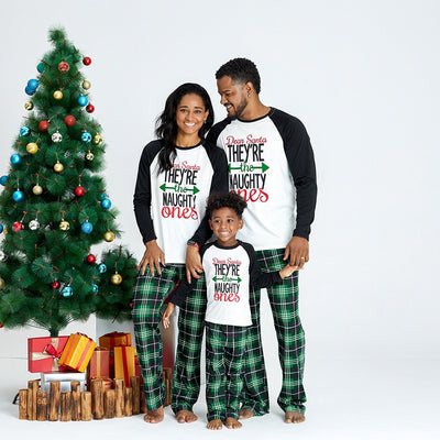 Family of four in matching Christmas pajamas with 'Dear Santa THEY'RE the NAUGHTY ones' graphic and green plaid pants. - Image 3