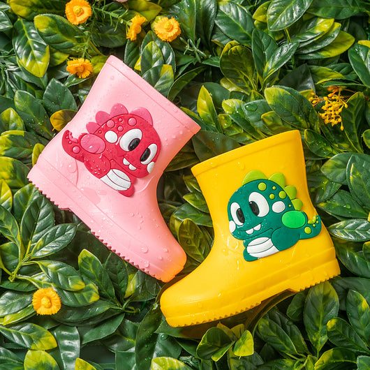 Bright yellow children's rain boots with a green cartoon dinosaur appliqué, designed for waterproof outdoor play. - Image 3