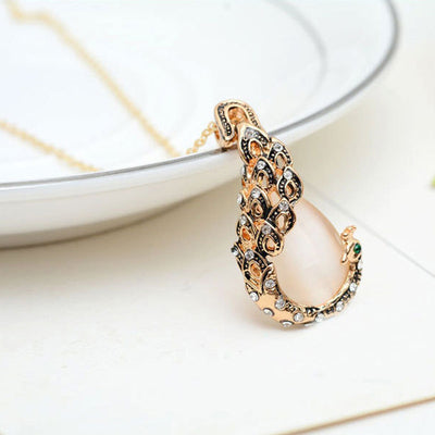Rose gold tone bridal jewelry set with a necklace and stud earrings, each featuring a large blue teardrop gem and clear accents. - Image 5