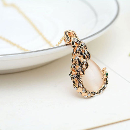 Rose gold tone bridal jewelry set with a necklace and stud earrings, each featuring a large blue teardrop gem and clear accents. - Image 5