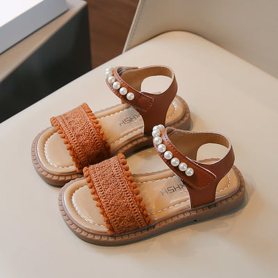Children's white sandals with pearl ankle straps, woven front strap, and brown sole, featuring a Velcro closure. - Image 4