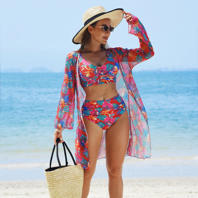 Multicolor tropical print three-piece swimsuit set with high-waisted bikini and sheer mesh cover-up on a beach. - Image 3
