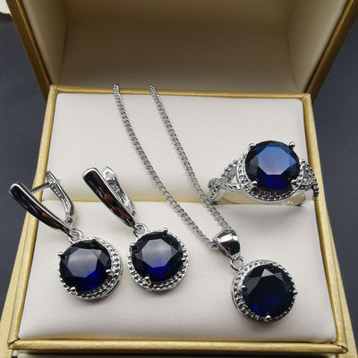 Four-piece silver-tone jewelry set with round green gemstones, including a necklace, bracelet, ring, and dangle earrings. - Image 26