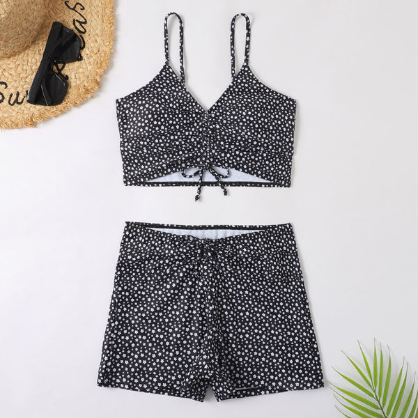 Blue two-piece swimsuit with white floral print, featuring a ruched crop top and matching boxer shorts. - Image 6