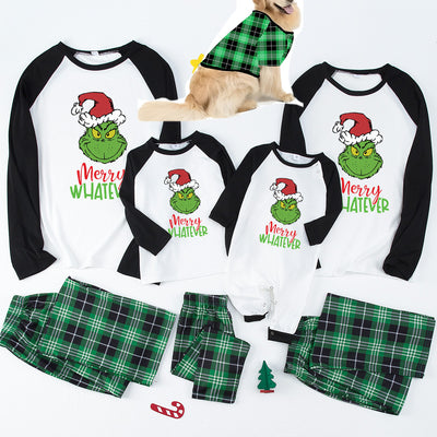Family of four and golden retriever in matching red and black plaid deer Christmas pajamas, by a decorated tree. - Image 8