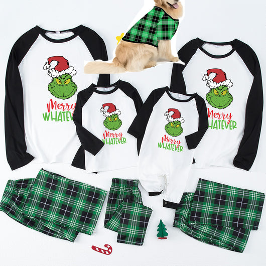 Family of four and golden retriever in matching red and black plaid deer Christmas pajamas, by a decorated tree. - Image 8