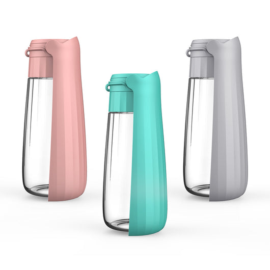Yellow 450ml portable pet water bottle with a folding drinking trough and white wrist strap, on grass. - Image 2
