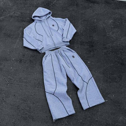 Light gray hooded tracksuit with dark gray contrast stitching, featuring a full-zip hoodie and matching loose sweatpants. - Image 2