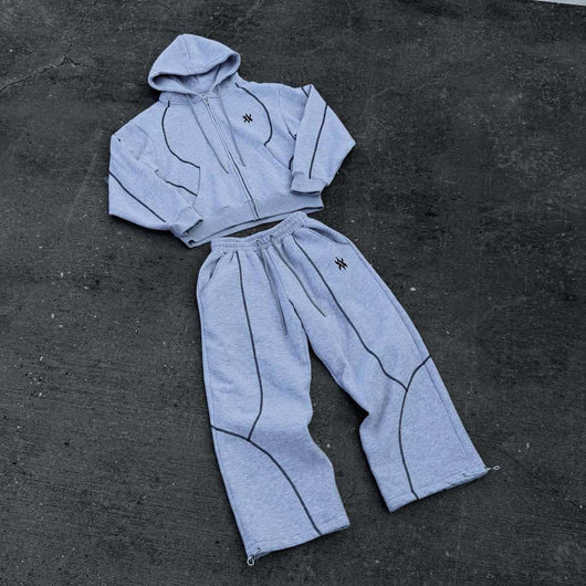 Light gray hooded tracksuit with dark gray contrast stitching, featuring a full-zip hoodie and matching loose sweatpants. - Image 2