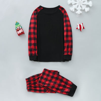 Family of five wearing matching black and red buffalo plaid Christmas pajamas with a white Christmas tree print. - Image 10