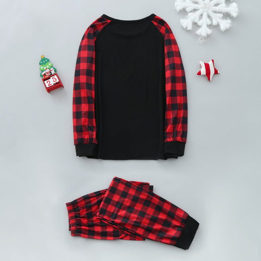 Family of five wearing matching black and red buffalo plaid Christmas pajamas with a white Christmas tree print. - Image 10