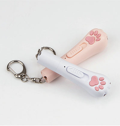Light purple paw-shaped cat laser pointer toy with USB charging, featuring multiple red laser patterns, soft white light, and UV light. - Image 24