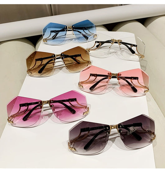 Rimless sunglasses with gradient pink lenses and gold-tone hollow temples, featuring a unique quadrilateral shape. - Image 14