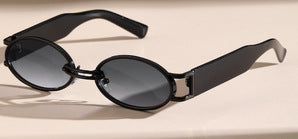 Retro small frame sunglasses with gold round frames and leopard print temples, held by a hand. - Image 6