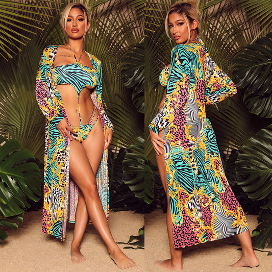 Women's fashion print two-piece swimsuit with a matching long-sleeve cape, featuring vibrant blue, yellow, pink, and black patterns.
