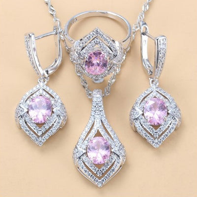 Silver-toned three-piece jewelry set with clear oval and round gems, including a necklace, dangle earrings, and a ring. - Image 13