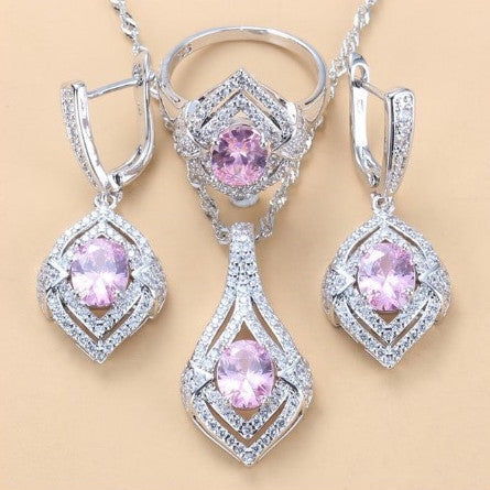 Silver-toned three-piece jewelry set with clear oval and round gems, including a necklace, dangle earrings, and a ring. - Image 13